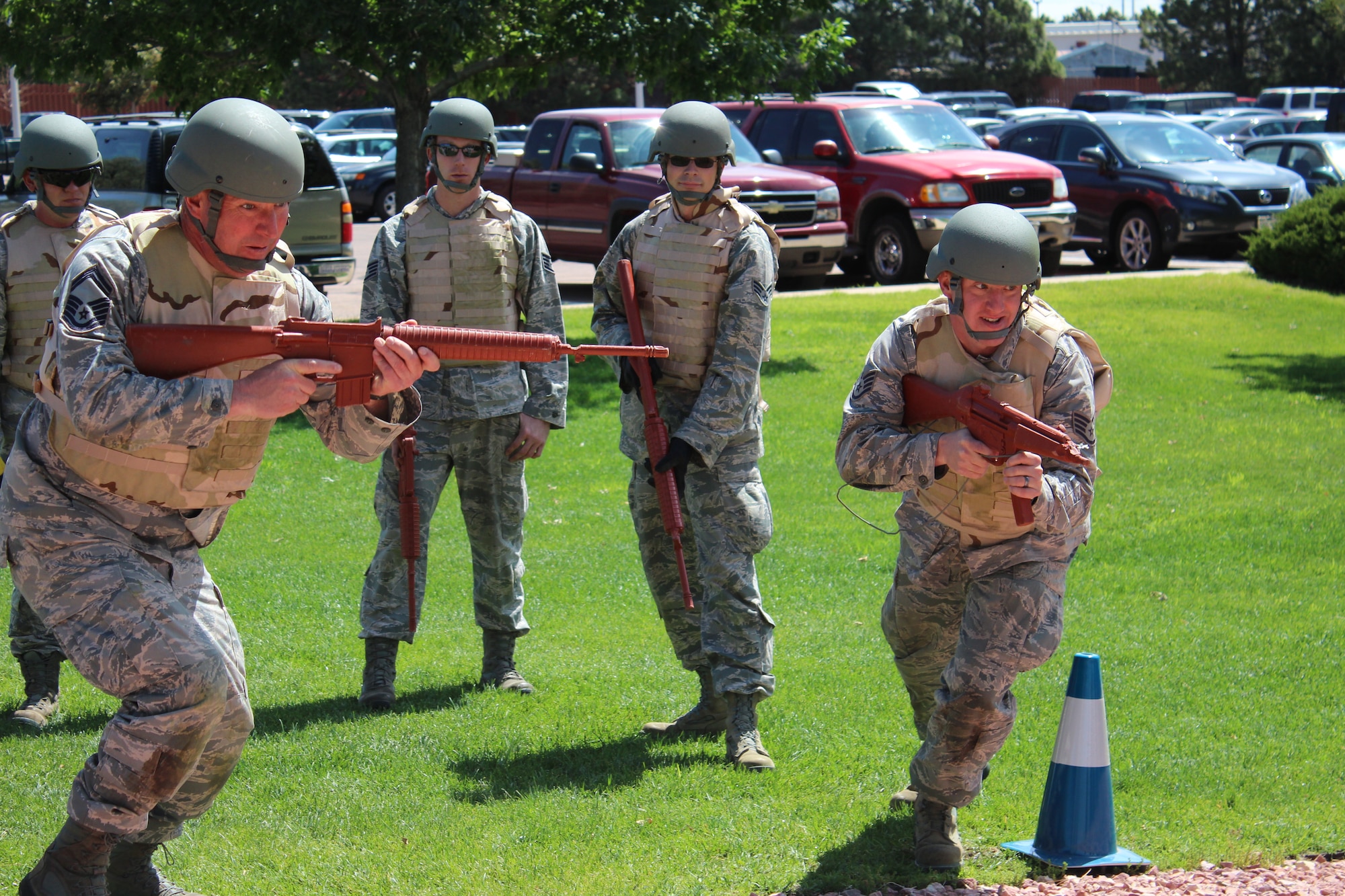 PETERSON AIR FORCE BASE, Colo. -- Newly promoted Chief Master Sgt. Lonnie Bacon (left) and Staff Sgt. Shane Clack, both members of the 21st Civil Engineer Squadron, practice a hostile street crossing scenario June 21, 2012, during the squadron’s monthly readiness training. The training ensures the squadron is ready to dominate its high ground. (U.S. Air Force photo/Staff Sgt. Shakib Rahman)