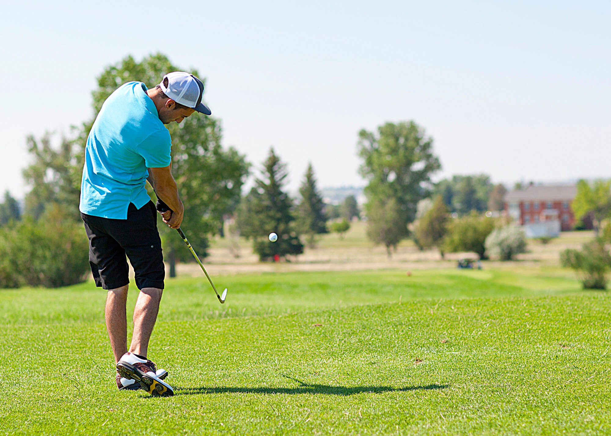 Senior Airman Matt Pollard, 90 Maintenance Operations Squadron, tees off during the Global Strike Challenge fundraising golf tournament. The tournament was held Thursday, July 12 at F.E. Warren golf course. (U.S. Air Force photo by Matt Bilden)