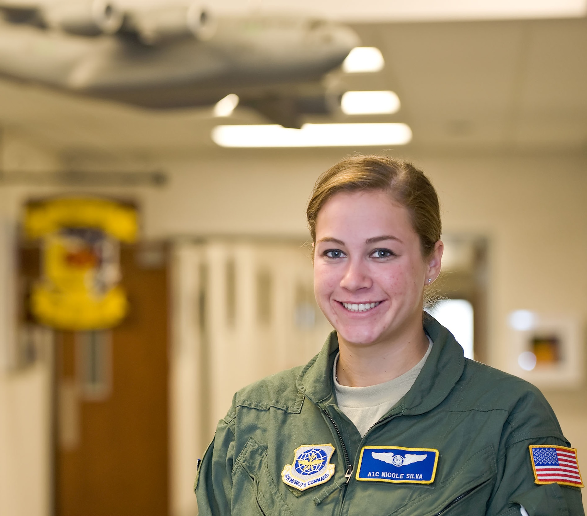 Airman 1st Class Nicole Silva, a C-17 Globemaster III loadmaster with the 3rd Airlift Squadron, poses for a picture, July 20, 2012 at Dover Air Force Base, Del. Silva was selected as Airman of the Week for the July 27, 2012 edition of The Airlifter. (U.S. Air Force photo/Roland Balik)