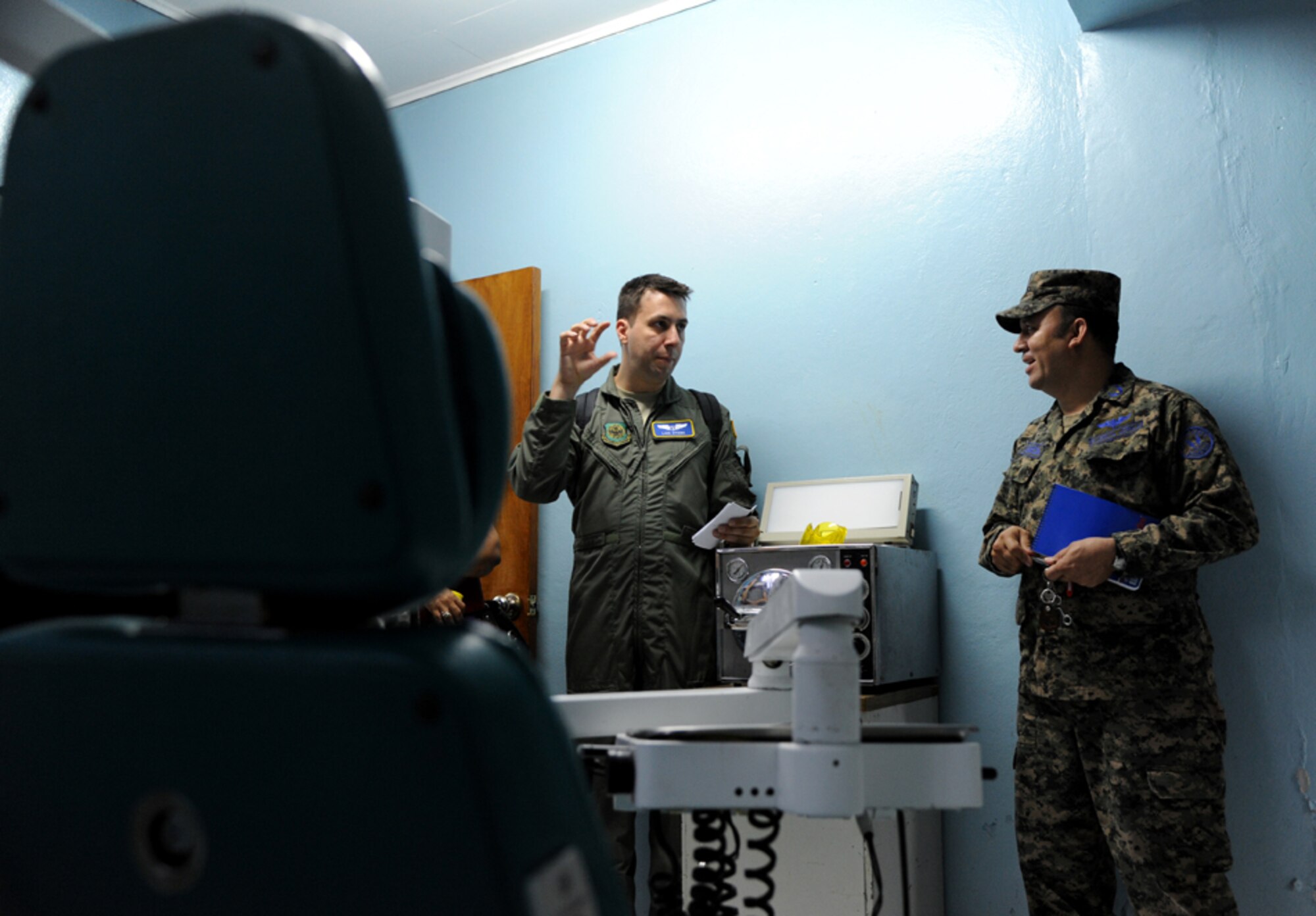 Major Luis Otero, a flight surgeon with the 60th Medical Operations Group discusses the dental equipment used in the clinic with a Honduran officer at Acosta Mejia Air Force Base, Tegucigalpa, Honduras on July 17, 2012.  Over the next 30 days Otero will meet with many Honduran clinic administrators to trade ideas and experiences to help each other as part of efforts to build partner capacity in between the U.S. and Honduran air forces.  (U.S. Air Force photo/Staff Sgt. James Stewart)