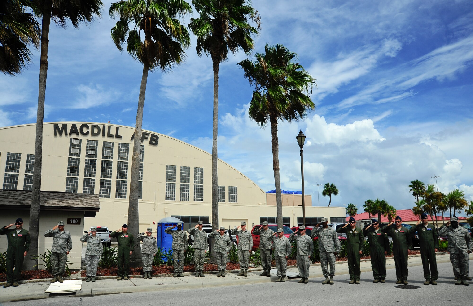 Service members line the streets of MacDill Air Force Base Fla., standing at attention and rendering salutes for fallen hero Army Staff Sgt. Ricardo Seija July 17, 2012. Service members are notified when a fallen hero is brought home though MacDill AFB and are given the opportunity to pay their respects as the hero's procession departs. (U.S. Air Force photo by Staff Sgt. Angela Ruiz)