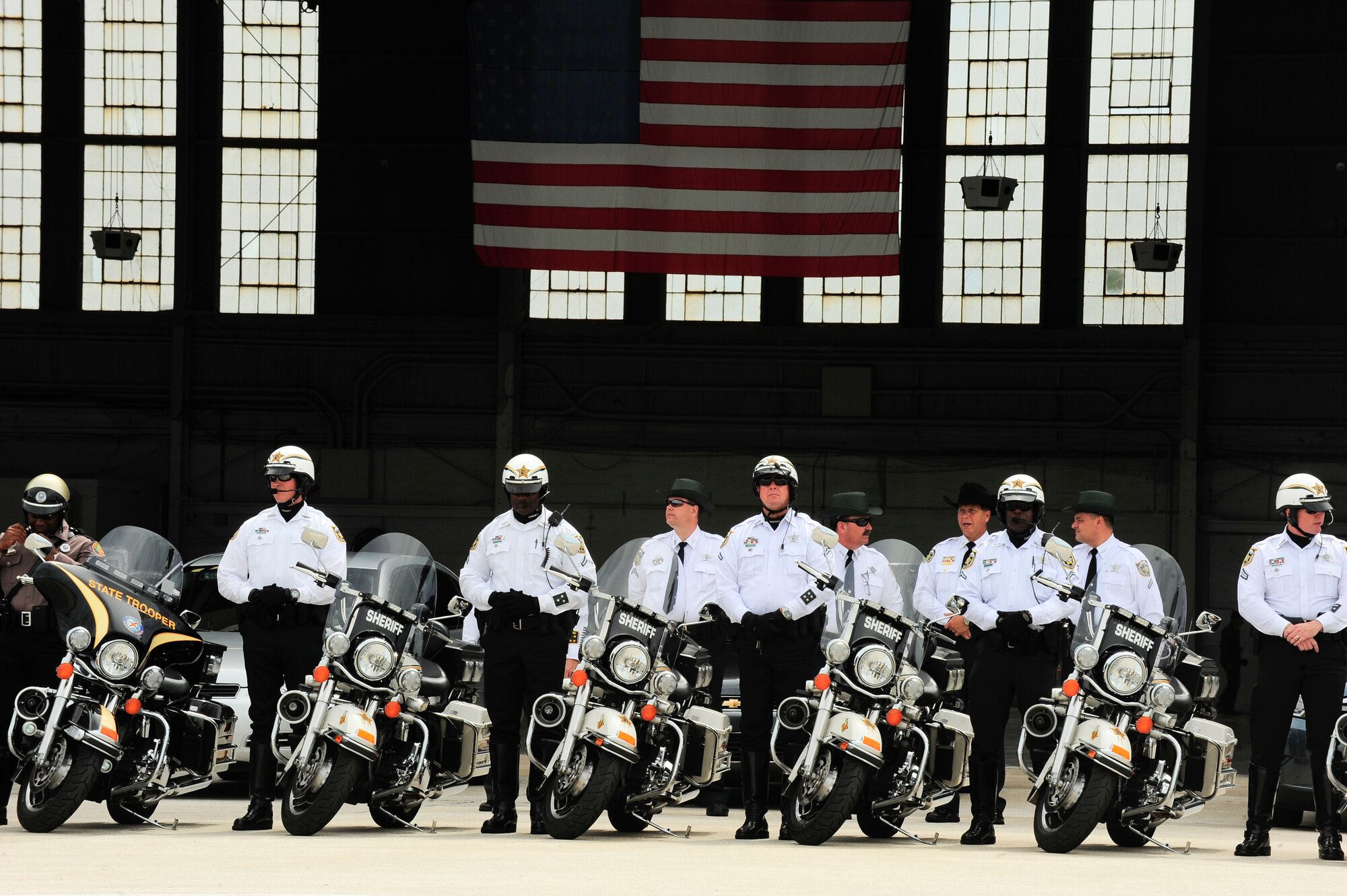 Hillsborough County Sheriff's Office deputies patiently stand by for the arrival of fallen hero Army Staff Sgt. Ricardo Seija July 17, 2012, on the flightline of MacDill Air Force Base, Fla. The deputies will escort Seija's procession ensuring the roadways are clear and secure. (U.S. Air Force photo by Staff Sgt. Angela Ruiz/Released)