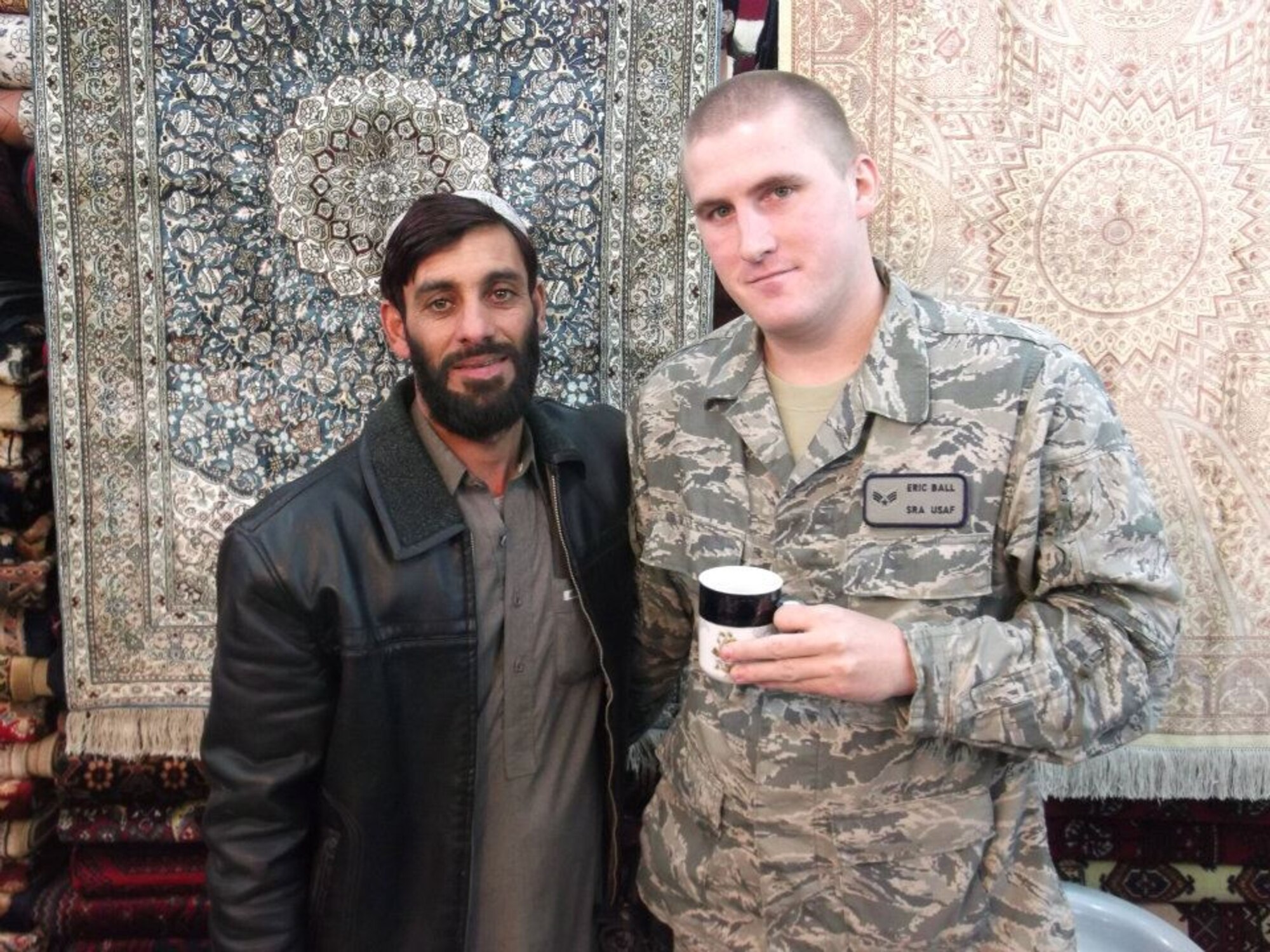 Senior Airman Eric Ball poses for a photo with an Afghani carpet merchant on Kandahar Air Base, Afghanistan. The six-month deployment was an experience Ball said was invaluable and allowed him to forge strong friendships with people from all over the world. (Courtesy photo)