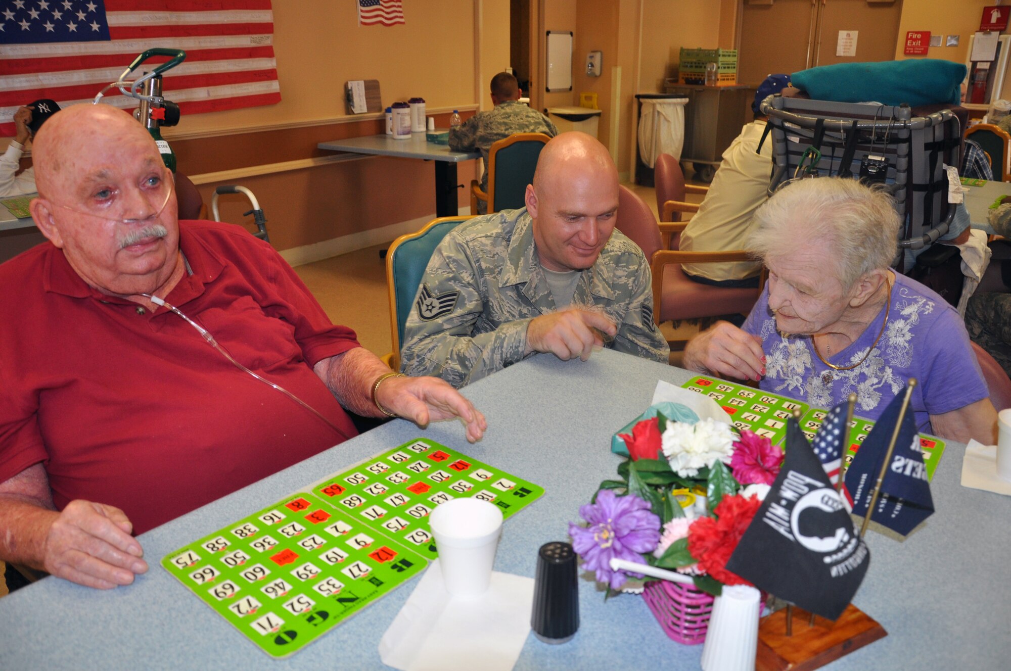 Staff Sgt. Kristopher Kreis, 90th Logistics Readiness Squadron, plays a game of Bingo with Harold Kercher and Mary Stockham during a Top 3-sponsored visit to the Cheyenne Veteran’s Affairs Clinic June 12. The visit affords the opportunity for Airmen to spend time with local veterans. (U.S. Air Force photo by Senior Airman Dan Gage)