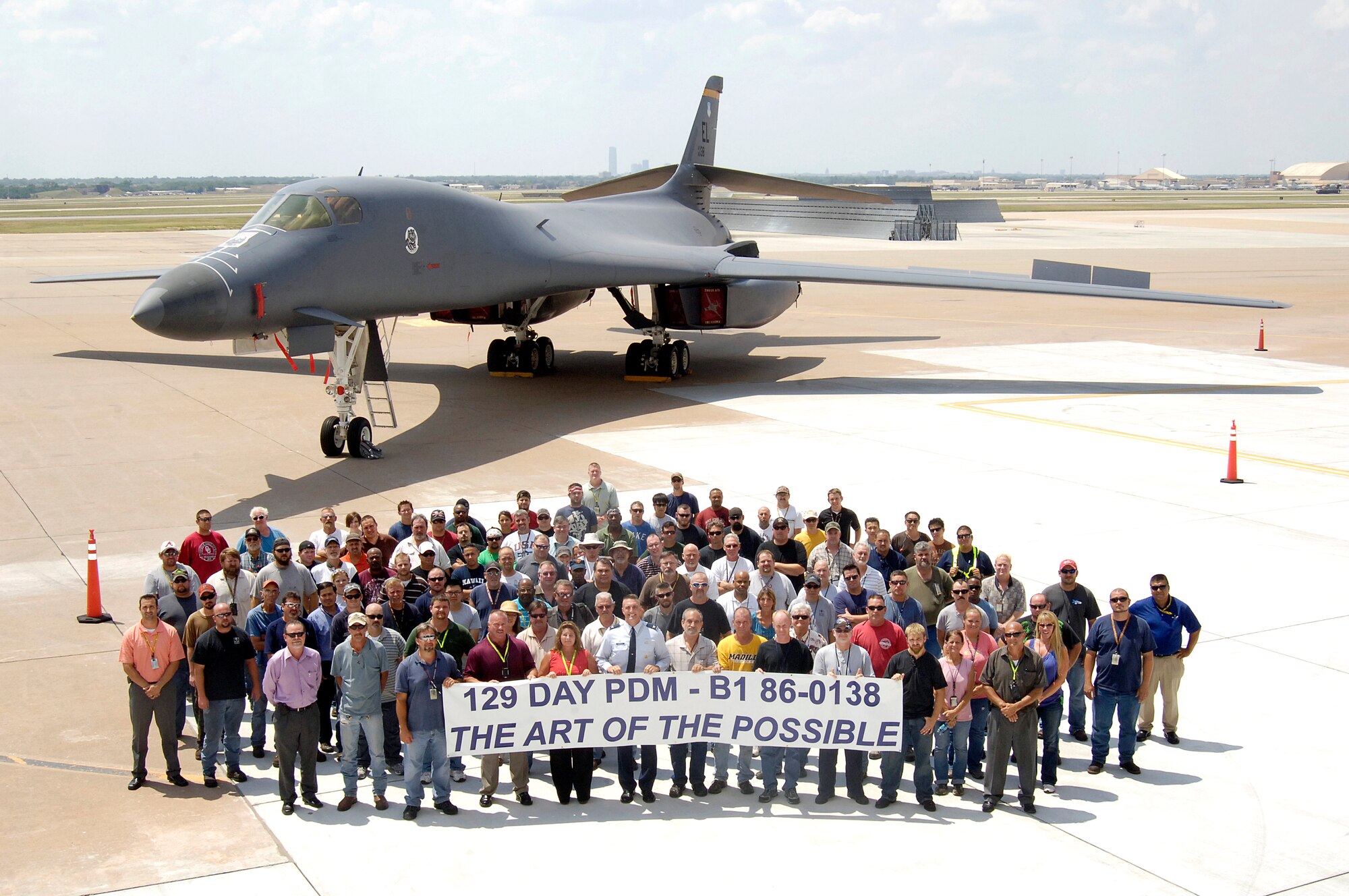 A banner says it all for the Oklahoma City Air Logistics Complex mechanics who produced a B-1 Bomber early and proudly delivered it to the customer this month.  Maintainers on the bomber even beat their own tight goals by finishing in 129 days. (Air Force photo by Margo Wright)
