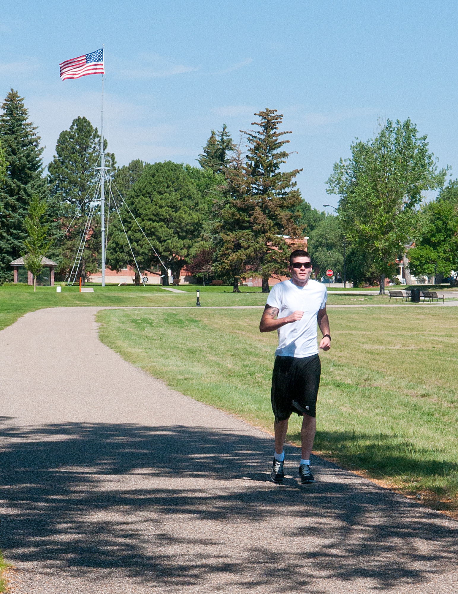 Airman 1st Class Kyle Neely, 90th Missile Security Forces Squadron, jogs on the F. E. Warren outdoor track July 12. During the summer when there is fairer weather, more people are using the track to exercise. (U.S. Air Force photo by Airman 1st Class Jason Wiese)