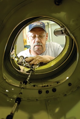 In the Air Refueling Boom Shop of the 551st Commodities Maintenance Squadron, John Ries reinstalls the electrical and hydraulics in a KC-135 refueling boom nozzle. The nozzle protects the boom. (U.S. Air Force photo/Margo Wright) 