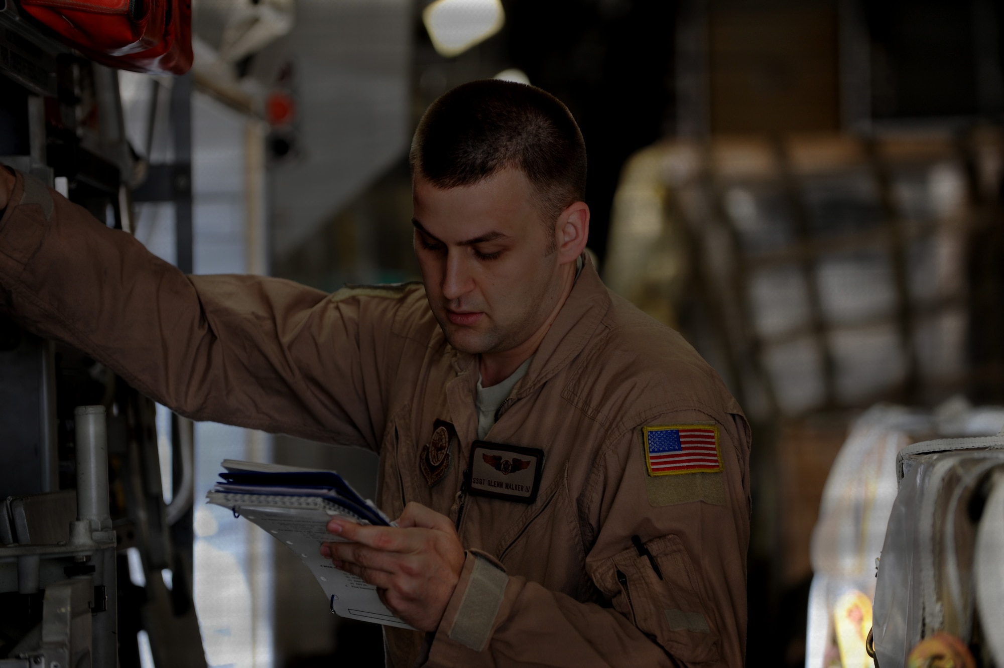 Staff Sgt. Glenn Walker II, 817th Expeditionary Airlift Squadron instructor loadmaster, refers to his manual while lowering the stabilizer struts aboard a C-17A Globemaster July 13, 2012, at Incirlik Air Base, Turkey. The 817th EAS has approximately 100 Airmen who operate out of Incirlik as well as the Transit Center at Manas,Kyrgyzstan, is a tenant unit to the 39th Air Base Wing. (U.S. Air Force photo by Senior Airman Jarvie Z. Wallace/Released) 