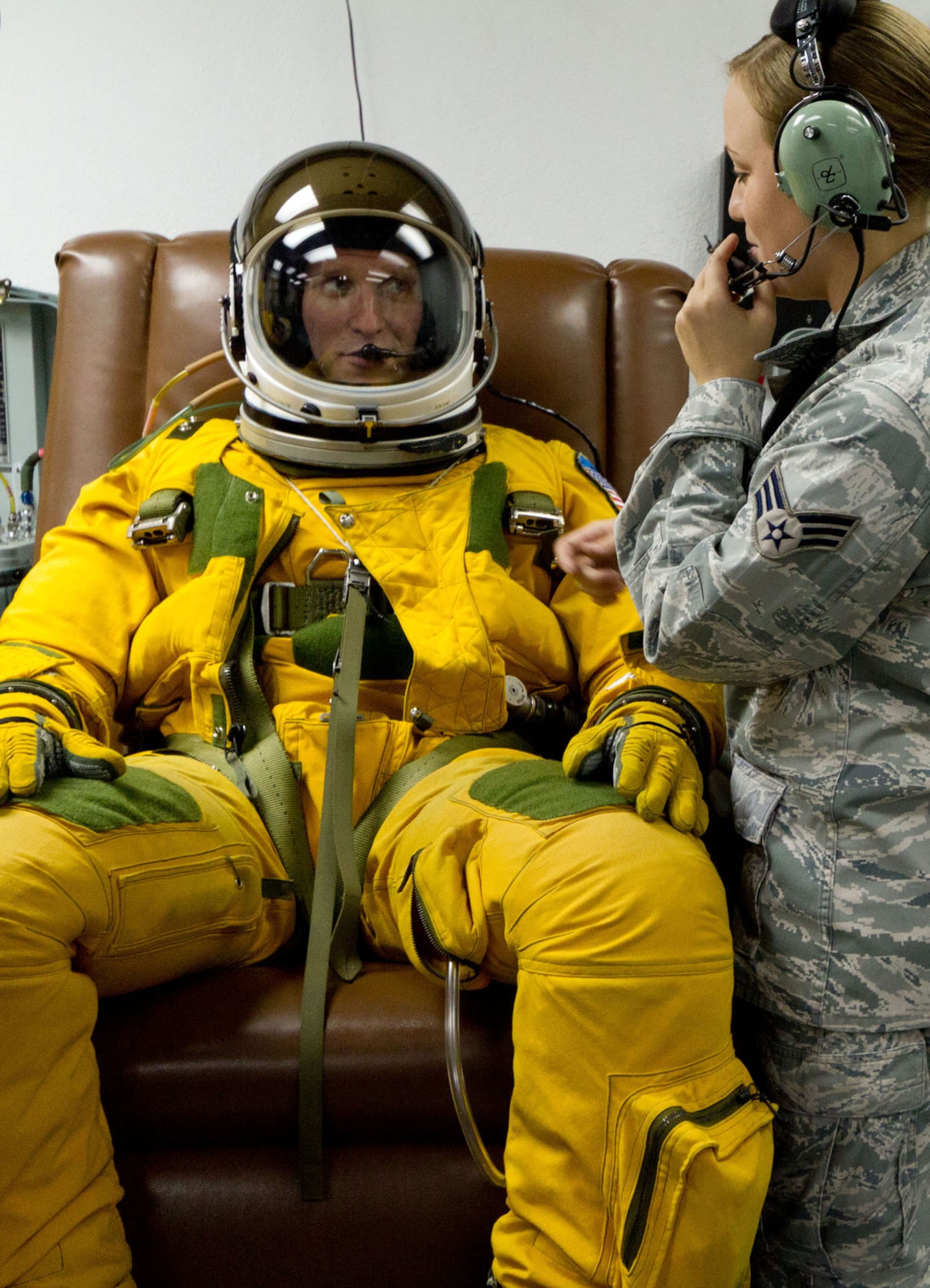 SOUTHWEST ASIA - U.S. Air Force Senior Airman Cortney Reeb, 99th Expeditionary Reconnaissance Squadron physiology support detachment technician, communicates with Capt. Peter, 99th ERS U-2 pilot, to verify his microphone is working properly July 17, 2012. The U-2 routinely flies at altitudes in excess of 70,000 feet, which requires the pilot to wear a full-pressure suit similar to that of astronauts.(U.S. Air Force photo/Senior Airman Alexander Recupero)