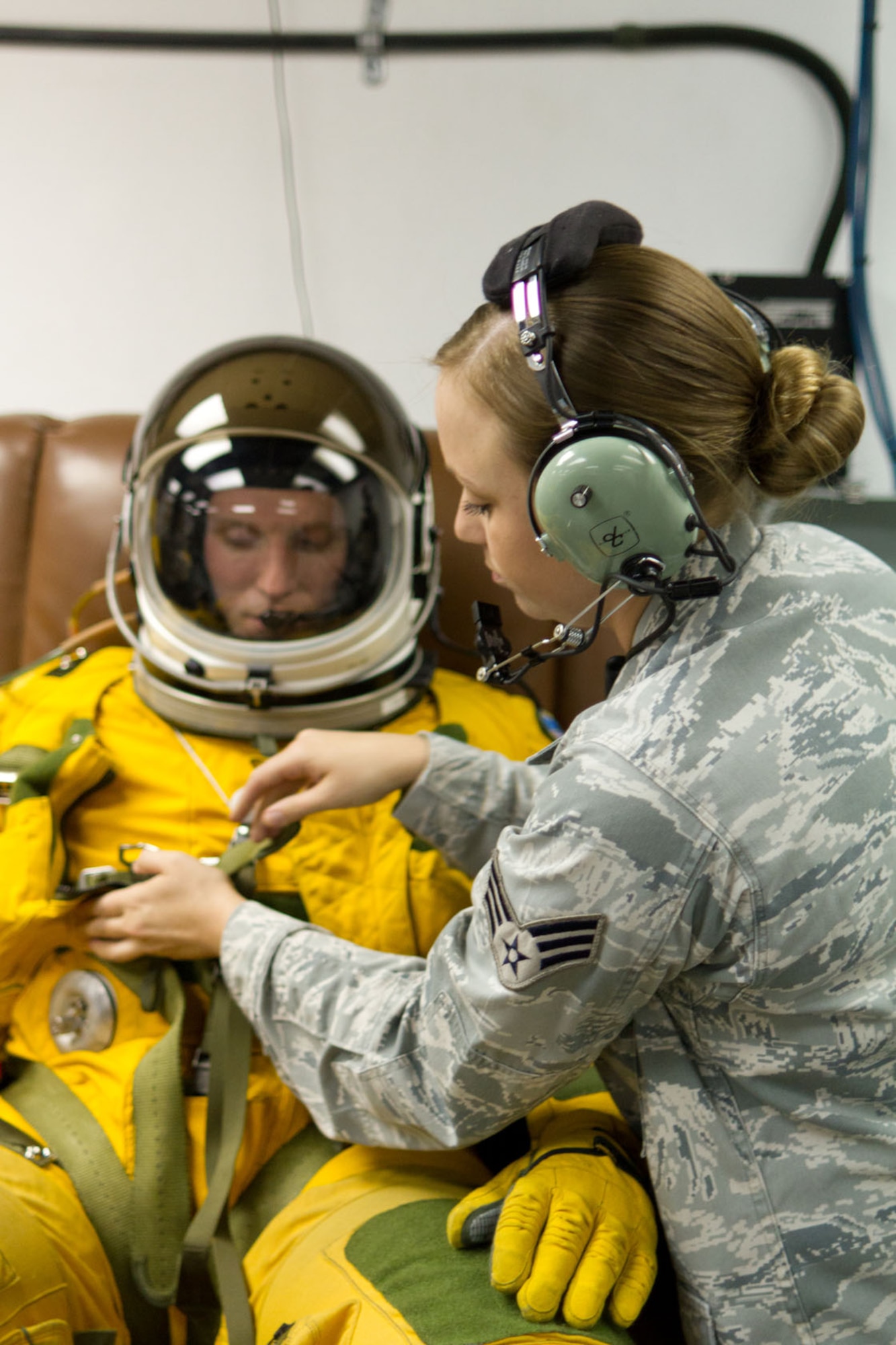 SOUTHWEST ASIA - U.S. Air Force Senior Airman Cortney Reeb, 99th Expeditionary Reconnaissance Squadron physiology support detachment technician, checks the air pressure valve on the full-pressure suit of Capt. Peter, 99th ERS U-2 pilot, July 17, 2012. Home based at Beale Air Force Base, Calif., U-2 pilots and support personnel are often rotated to operational detachments worldwide. (U.S. Air Force photo/Senior Airman Alexander Recupero)