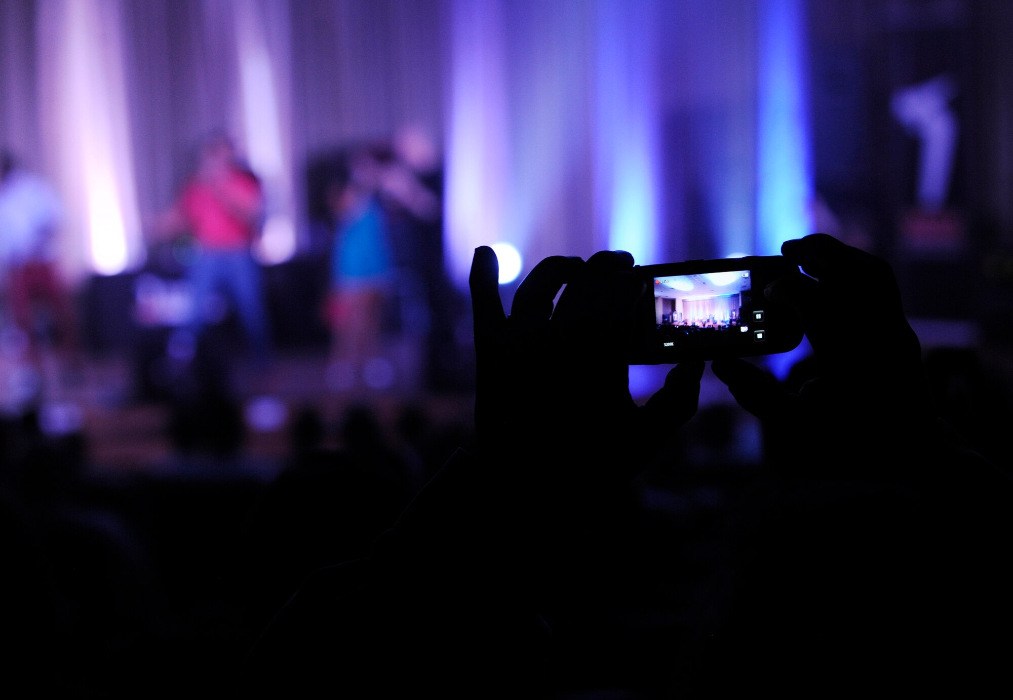 SOUTHWEST ASIA – A servicemember takes a photo during The American Idol World Tour concert here July 15. The tour will travel to 27 military installations throughout 12 countries – including Korea, Japan, Guam, Greece, Italy, Portugal, Turkey, Egypt, the United Kingdom, the Netherlands and locations in the Middle East – bringing entertainment to more than 30,000 troops and their families. (U.S. Air Force photo/Staff Sgt. Alexandra M. Boutte)