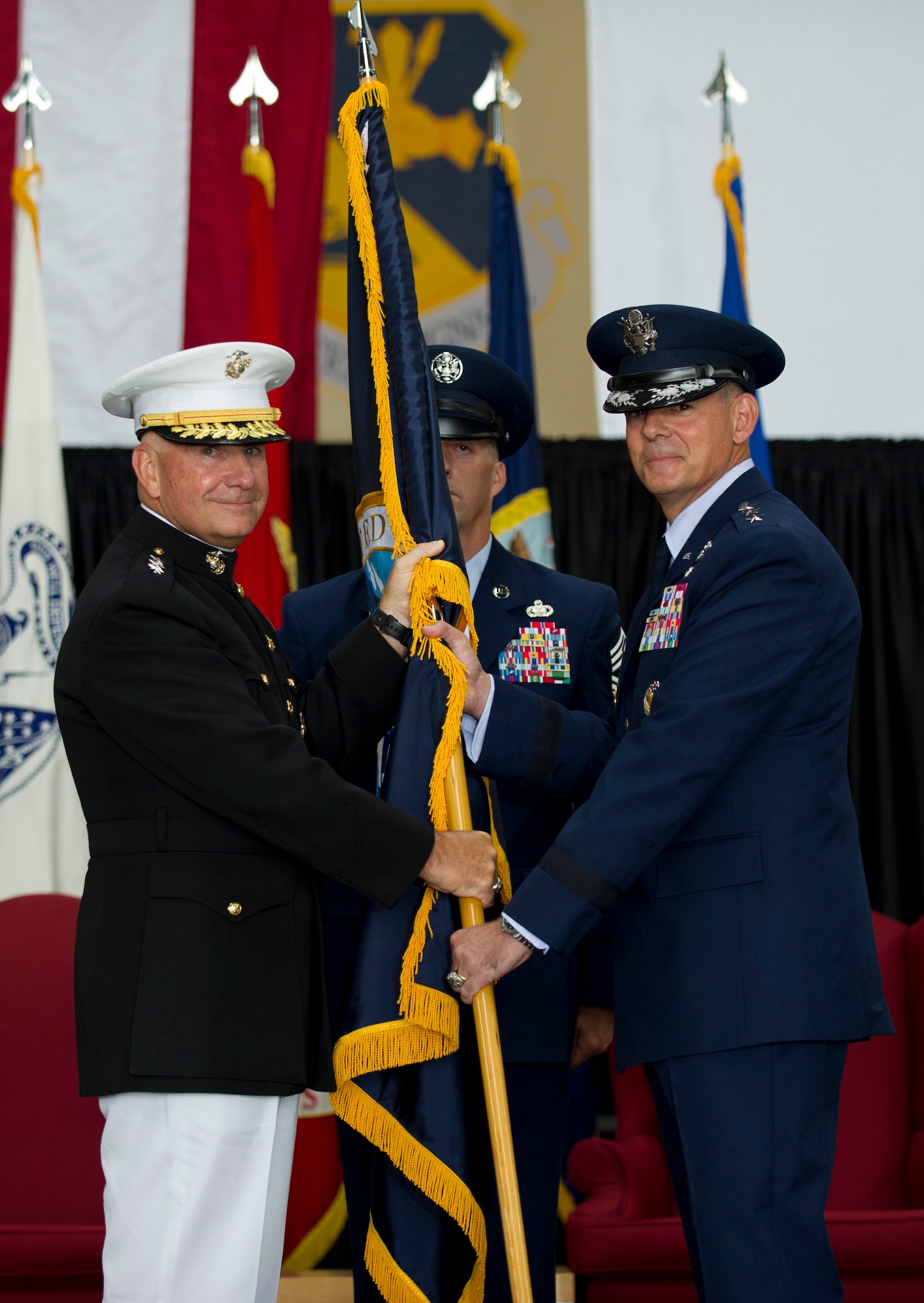 YOKOTA AIR BASE, Japan -- Lt. Gen. Thomas Conant, U.S. Pacific Command deputy commander, passes the guidon to Lt. Gen Sam Angelella, U.S. Forces, Japan, and 5th Air Force commander, during a change of command ceremony at Yokota Air Base, Japan, July 20, 2012. Passing the guidon is symbolic of passing the responsibility of command, a tradition dating back to Roman times. (U.S. Air Force photo by Staff Sgt. Stacy Moless)