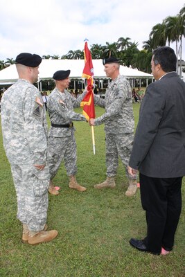 FORT SHAFTER, HI — Lt. Col. Thomas D. Asbery (back right) receives the unit colors from Pacific Ocean Division Commander Brig. Gen. Richard L. Stevens becoming the 68th Commander of the U.S. Army Corps of Engineers Honolulu District July 18, 2012. Looking on are outgoing District Commander Lt. Col. Douglas B. Guttormsen (front left), and Anthony J. Paresa, Deputy District Engineer and Chief, Programs and Project Management Division. Stevens hosted the ceremony at Historic Palm Circle Parade Field at Fort Shafter, Hawaii. For his outstanding work and contributions to the Honolulu District, Guttormsen received the Meritorious Service Medal. Guttormsen leaves to become the Division Engineer for the 25th Infantry Division, Schofield Barracks, Hawaii. Asbery most recently served as the Executive Officer to the Commanding General, Human Resources Command, Fort Knox, Kentucky. Asbery deployed twice in support of Operation Iraqi Freedom. He also deployed to the Mississippi Coast in support of Hurricane Katrina disaster relief efforts in 2005 as a Forward Engineer Support Team leader. 
