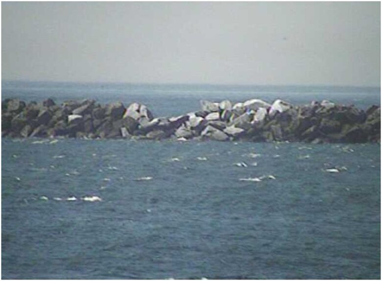 An image from a temporarily-installed U.S. Army Corps of Engineers monitoring camera on a U.S. Coast Guard station in Neah bay show areas in the outer breakwater needing repair. The Corps’ Seattle District will begin repairs Monday. Cost of repairs to reestablish the crest width to 25 feet and 18 feet above mean lower low water is $2.19 million.  (U.S. Army Corps of Engineers photo/released)