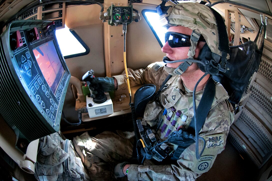 U.S. Army Pfc. Colin Rafferty operates a remote gun turret from within a mine-resistant, ambush-protected vehicle while on a mission to escort his battalion commander to a security meeting in the Qara Bagh district in Afghanistan's Ghazni province, July 16, 2012. Rafferty is assigned to the 82nd Airborne Division's 2nd Battalion, 504th Parachute Infantry Regiment, 1st Brigade Combat Team.
