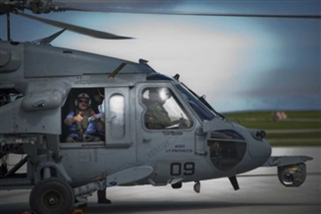 Deputy Secretary of Defense Ashton B. Carter gives a thumbs-up prior to an aerial tour of Guam in a U.S. Navy HS-60B Sea Hawk on July 20, 2012.  Carter stopped in Guam in the midst of a 10-day Asia Pacific trip where he will meet with partners in Japan, Thailand, India and South Korea.  