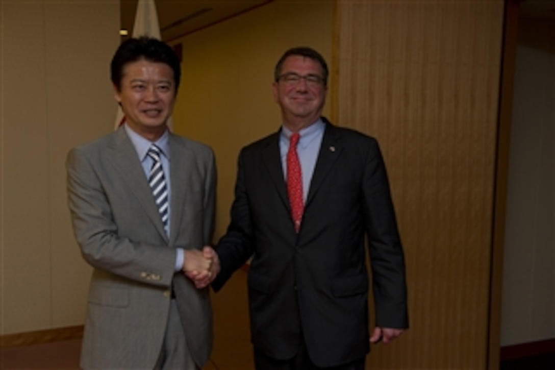 Deputy Secretary of Defense Ashton B. Carter and Japanese Foreign Minister Koichiro Gemba pose for photographers before their meeting in Tokyo, Japan, on July 20, 2012.   Japan is the third stop for Carter in a 10-day Asia-Pacific trip.  