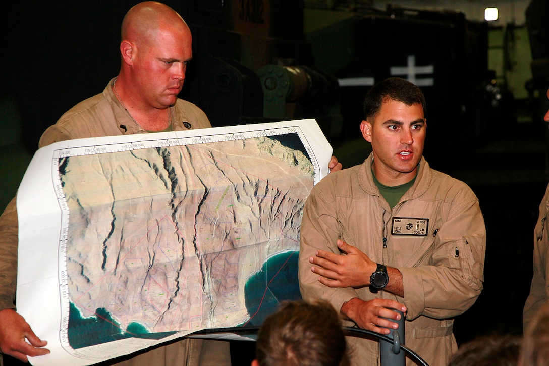 First Lt. Josh M. Coelho, platoon commander, Assault Amphibious Vehicle Platoon, India Company, Battalion Landing Team 3/5, 15th Marine Expeditionary Unit, briefs his Marines on their upcoming training, aboard the USS Green Bay, July 20. The AAV platoon practiced water gunnery, an advanced level of AAV gunnery, in preparation for the 15th MEU’s upcoming deployment. The training was part of Composite Training Unit Exercise, the second at-sea period the 15th MEU and Peleliu Amphibious Ready Group have conducted since the MEU formed a Marine Air Ground Task Force in February. The training will prepare the two units to function as a blue-green team, capable of conducting a wide-variety of worldwide missions ranging from humanitarian aid to combat.