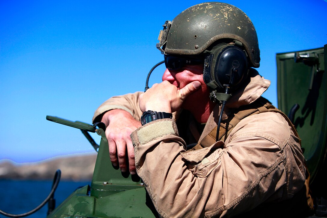 Gunnery Sgt. Zackary J. Hefty, platoon sergeant, Assault Amphibious Vehicle platoon, India Company, Battalion Landing Team 3/5, 15th Marine Expeditionary Unit, supervises the training his platoon is conducting, off of San Clemente Island, July 20. The AAV platoon practiced water gunnery, an advanced level of AAV gunnery, in preparation for the 15th MEU’s upcoming deployment. The training was part of Composite Training Unit Exercise, the second at-sea period the 15th MEU and Peleliu Amphibious Ready Group have conducted since the MEU formed a Marine Air Ground Task Force in February. The training will prepare the two units to function as a blue-green team, capable of conducting a wide-variety of worldwide missions ranging from humanitarian aid to combat. Hefty, 31, is from Oceanside, Calif.