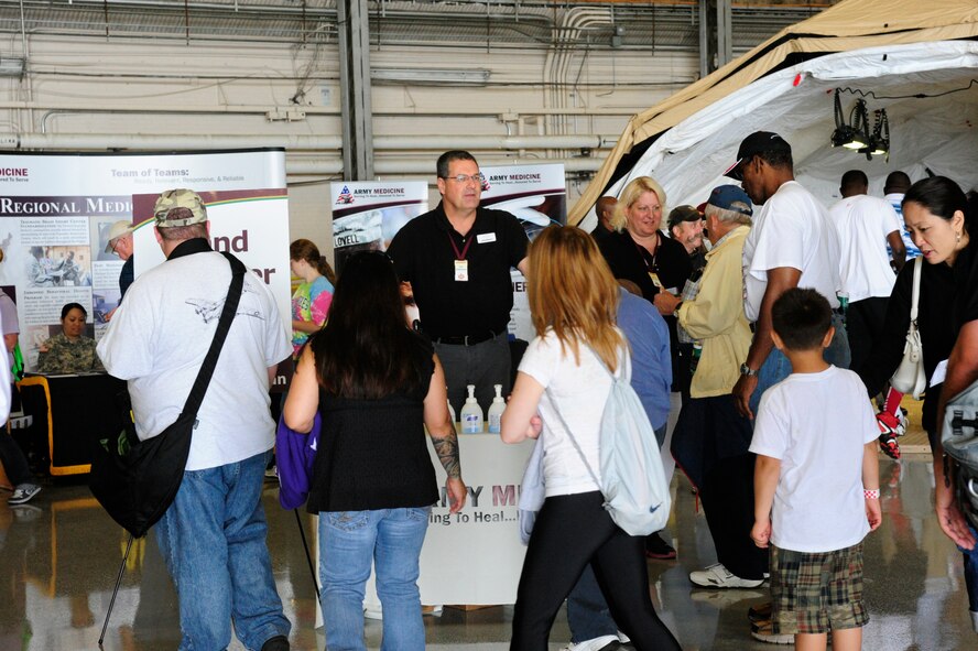 Members of the Madigan Healthcare System hand out ear plugs at their booth July 21, 2012, during the 2012 Joint Base Lewis-McChord Air Expo at McChord Field, Wash. (U.S. Air Force photo/Staff Sgt. Frances Kriss)