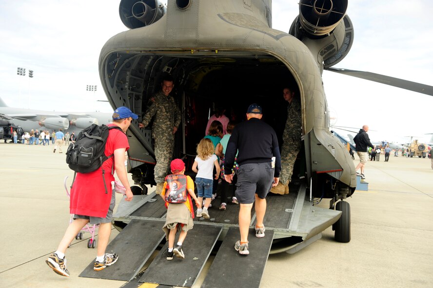 A group enters a CH-47 “Chinook” helicopter July 21, 2012, during the 2012 Joint Base Lewis-McChord Air Expo at McChord Field, Wash. The Chinook was one of more than 40 static aircraft displays at the 2012 Joint Base Lewis-McChord Air Expo. (U.S. Air Force photo/Staff Sgt. Frances Kriss)