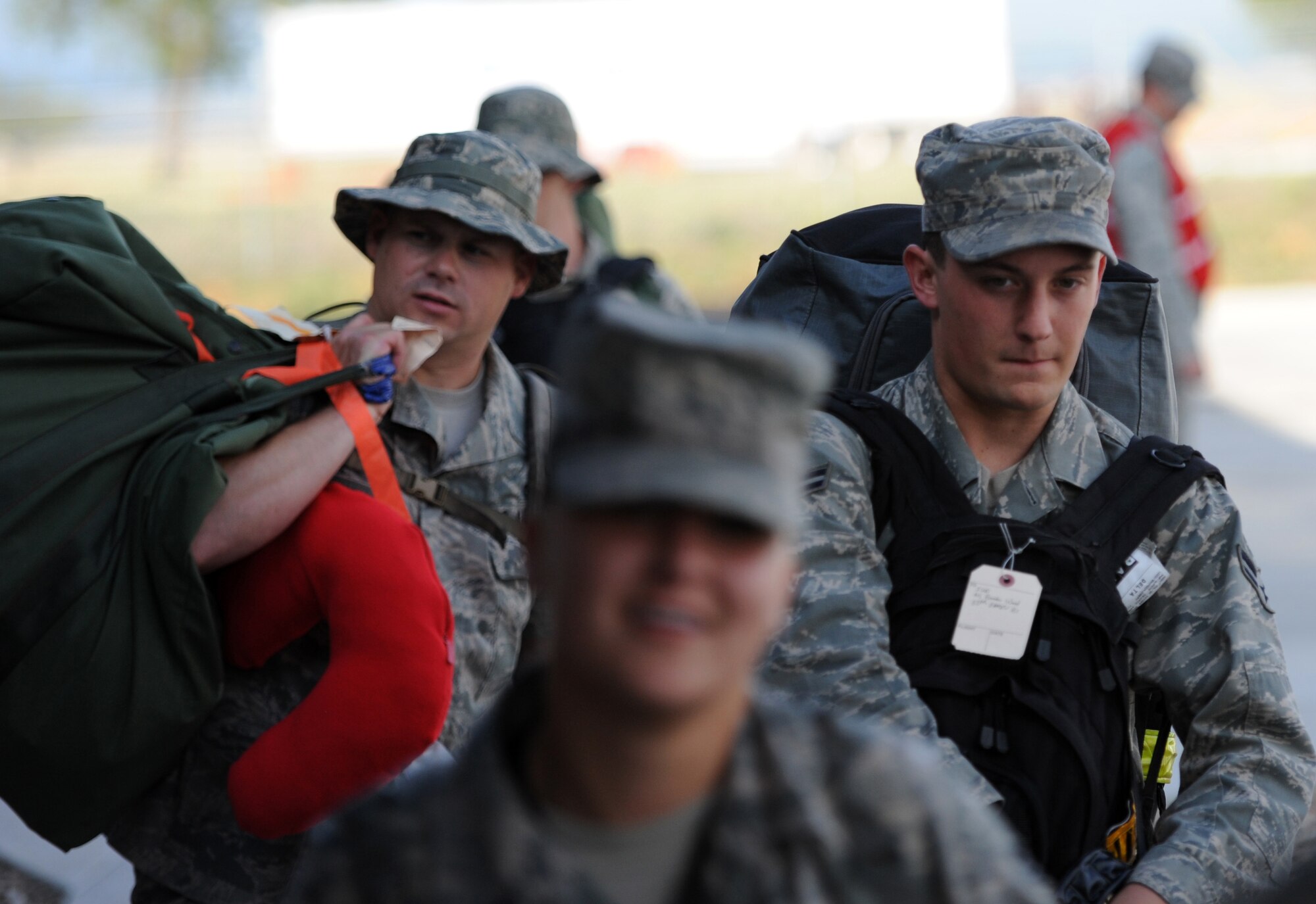 Airmen from a variety of squadrons unload from their bus at the new deployment center at Ellsworth Air Force Base, S.D. on July 21, 2012, beginning their trek to Southwest Asia. Ellsworth aircrews will conduct B-1 missions designed to rapidly deliver massive quantities of precision and non-precision weapons against adversaries. (U.S. Air Force photo by Airman 1st Class Hrair H. Palyan/Released)