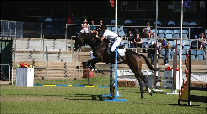 A competitor clears a jump during an equestrian show-jumping competition at the 46th annual Katherine Show in Katherine, Northern Territory, Australia, July 21, 2012. Competitors entered in 10 different classes.