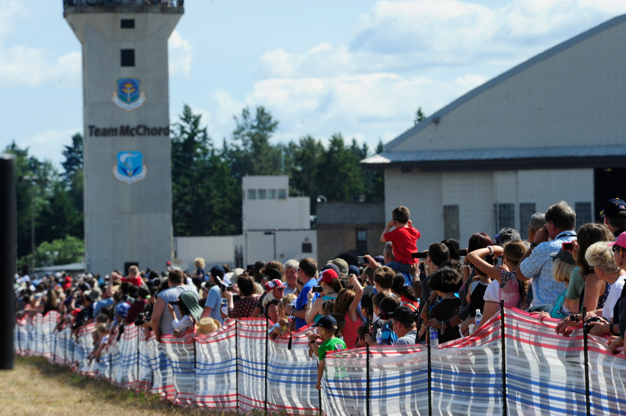 Visitors take photos and video of the different flying performances July 21, 2012, during the 2012 Joint Base Lewis-McChord Air Expo at McChord Field, Wash. (U.S. Air Force photo/Staff Sgt. Frances Kriss)