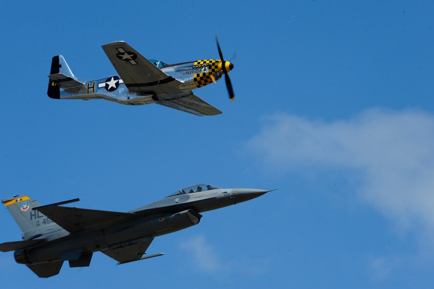 A P-51 Mustang and an F-16 Fighting Falcon fly together as part of a Heritage Flight July 21, 2012, during the 2012 Joint Base Lewis-McChord Air Expo at McChord Field, Wash. The Heritage Flight shows the evolution of the Air Force by flying today's state-of-the-art fighter aircraft in close formation with another vintage fighter aircraft. (U.S. Air Force photo/Staff Sgt. Frances Kriss)