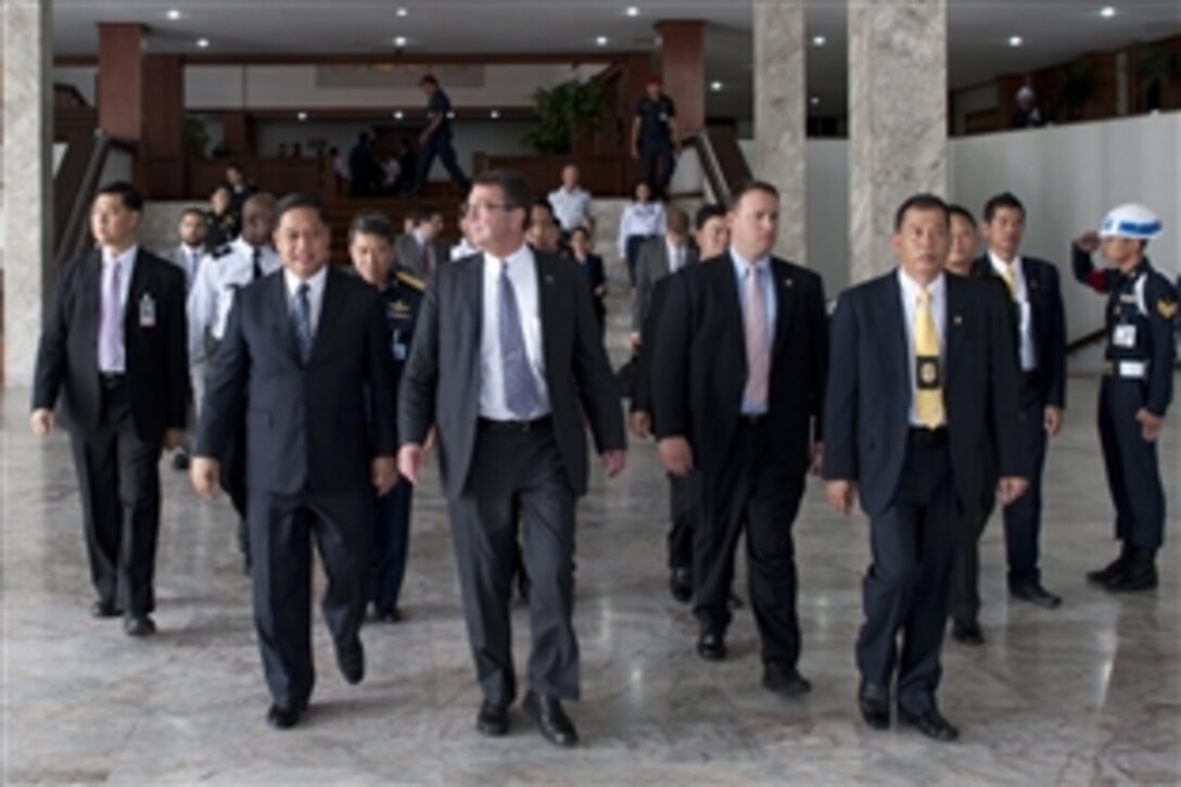 U.S. Deputy Defense Secretary Ashton B. Carter, center, departs the Thai Ministry of Defense building with Thai Air Chief Marshal Sukumpol Suwanatat, left foreground, Thailand's Minister of Defense, in Bangkok, July 22, 2012. Carter is on a 10-day Asia-Pacific trip meeting partners in Hawaii, Guam, Japan Thailand, India and South Korea.