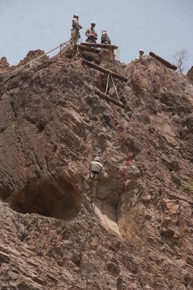 U.S. Marine Sgt. Jason Schmus, 24th Marine Expeditionary Unit assault climbing instructor, repels down a mountain July 22. Schmus was doing a practice run, inspecting the ropes for any weaknesses and checking for loose rocks. French and U.S. Marines participated in an assault climbing course in the rugged terrain of the Arta Range July 19 - 30.