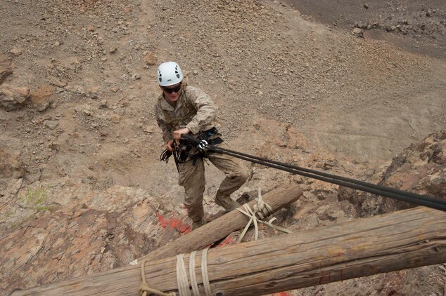 A U.S. Marine repels down the side of a cliff during an assault climbers course July 22. French and U.S. Marines participated in an assault climbing course in the rugged terrain of the Arta Range July 19 - 30.