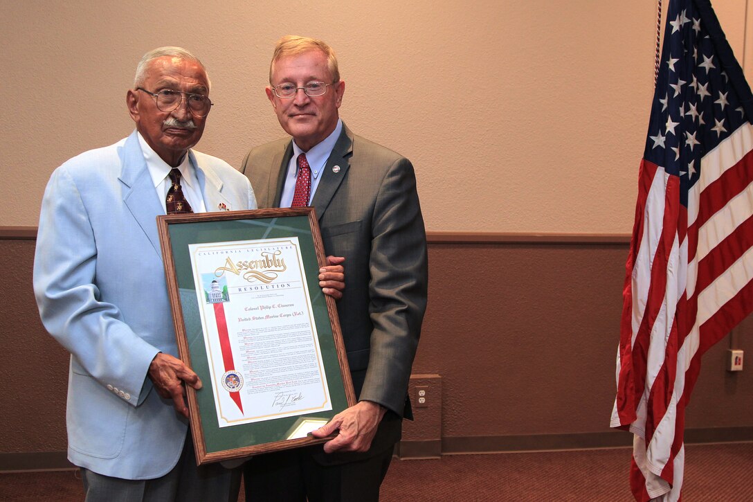 Retired Col. Philip C. Cisneros (left), this year's Veteran of the Year recipient from the 65th Assembly District of the California Legislature, shows off his framed certificate, alongside Assemblyman Paul Cook, who presented him with the award.