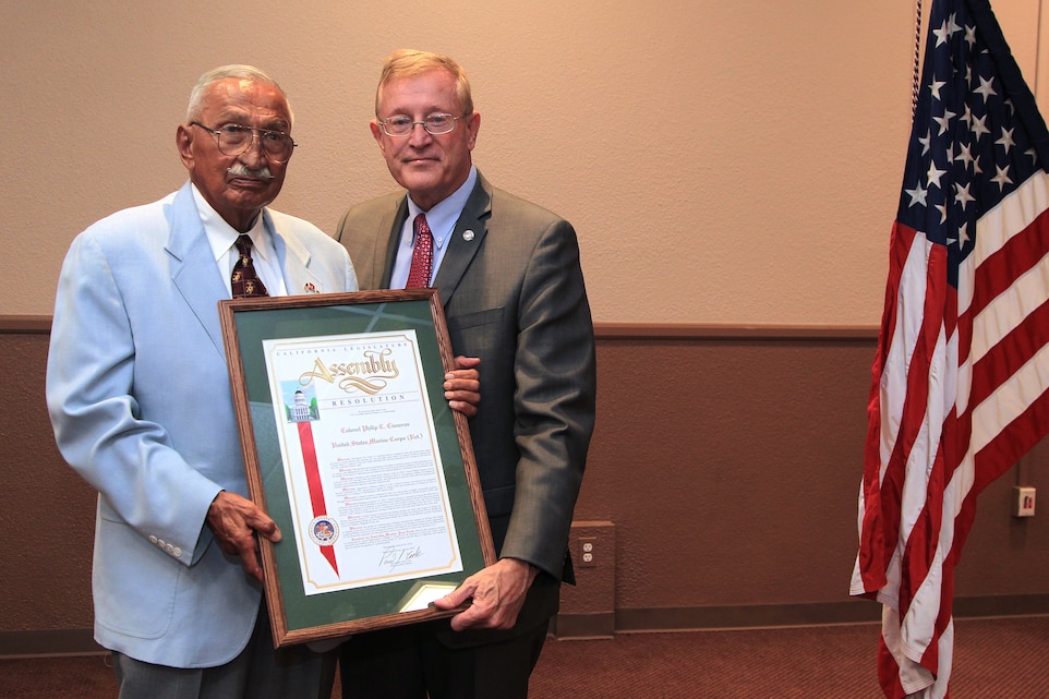 Retired Col. Philip C. Cisneros (left), this year's Veteran of the Year recipient from the 65th Assembly District of the California Legislature, shows off his framed certificate, alongside Assemblyman Paul Cook, who presented him with the award.