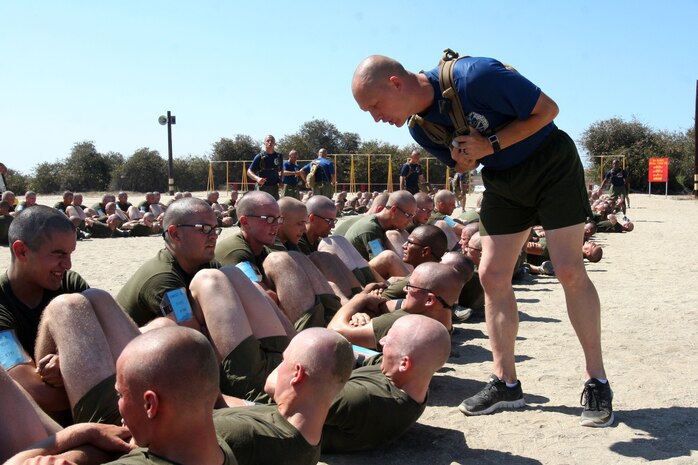 Drill instructors with Company I, 3rd Recruit Training Battalion, encourage recruits to push their limits as the finsih the final part of the initial physical fitness test July 20 aboard Marine Corps Recruit Depot San Diego. A PFT consists of a maximum set of pull-ups, a timed three-mile run and a max set of timed crunches. Recruits run an initial PFT to see how much they've improved since the beginning of recruit training.