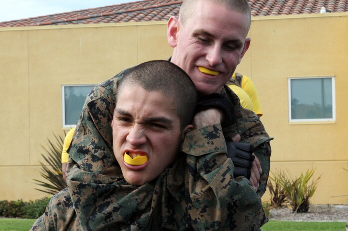 Recruits of Company F, 2nd Recruit Training Battalion, take turns demonstrating their ability to perform chockes aboard Marine Corps Recruit Depot San Diego July 18. Chokes, leg sweeps and arm manipulations were some of the techniques Co. F recruits were tested on in order to receive their tan belts in Marine Corps Martial Arts.