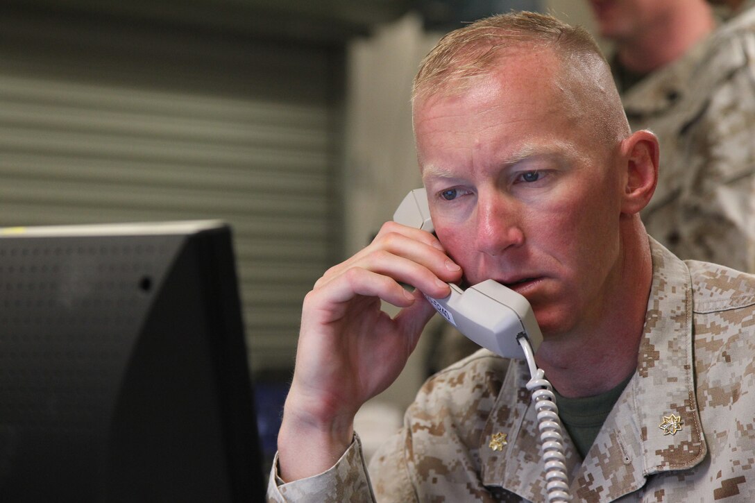 Maj. Ben Brown, exercise controller, LSE-1/JT12, spends time on the phone going over exercise details for LSE-1/JT12 at the exercise control center July 3, 2012.