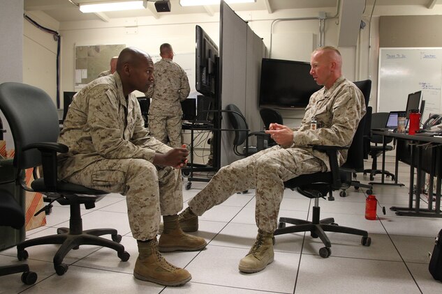 Maj. Ben Brown, exercise controller, LSE-1/JT12, speaks with Capt.
Elishama Wheeler, communications planner, Combat Center Operations, about details of LSE-1/JT12 at the exercise control center July 3, 2012.
