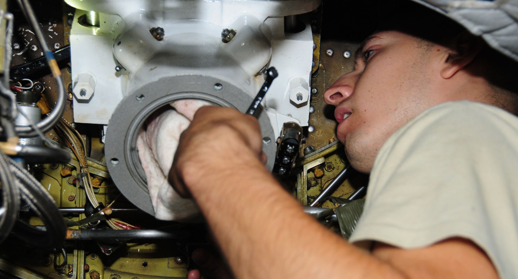 Andersen Air Force Base, Guam- Airman 1st Class Javier Peralta, 69th Expeditionary Aircraft Maintenance Unit hydraulics maintainer, works on an in-flight refueling receptacle during maintenance on a B-52 Stratofortress aircraft July 19. The 36th Expeditionary Aircraft Maintenance Squadron is currently deployed from Minot Air Force Base, ND to Andersen and works to ensure mission readiness. (U.S. Air Force photo by Senior Airman Benjamin Wiseman/Released)