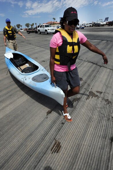 U.S. Air Force Chaplain (Lt. Col.) Stephen Voyt, 23d Wing chaplain, and Master Sgt. Tonette Pryor, 23d Operations Support Squadron first sergeant, carry a kayak to the water at Lake Mead National Recreation Area July 21, 2012.  Voyt and Pryor are deployed to Nellis Air Force Base, Nev., in support of exercise Red Flag 12-4.  The chaplain organized a morale trip for 16 Red Flag participants that included kayaking, hiking and swimming at Lake Mead. (U.S. Air Force photo by Master Sgt. Sonny Cohrs/Released)