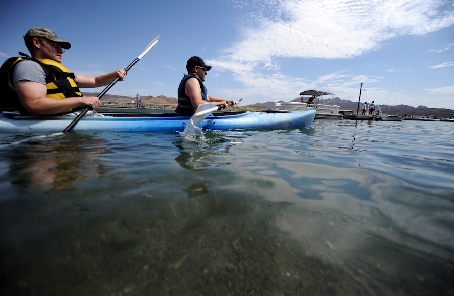 U.S. Air Force Staff Sgt. Kyle Baldwin and Airman 1st Class Branden Katt, 74th Fighter Squadron, paddle out of the marina at Lake Mead National Recreation Area July 21, 2012, for kayak trip with Outdoor Adventures from Nellis Air Force Base, Nev.  The Airmen are deployed to Nellis from Moody Air Force Base, Ga., in support of exercise Red Flag 12-4. (U.S. Air Force photo by Master Sgt. Sonny Cohrs/Released)