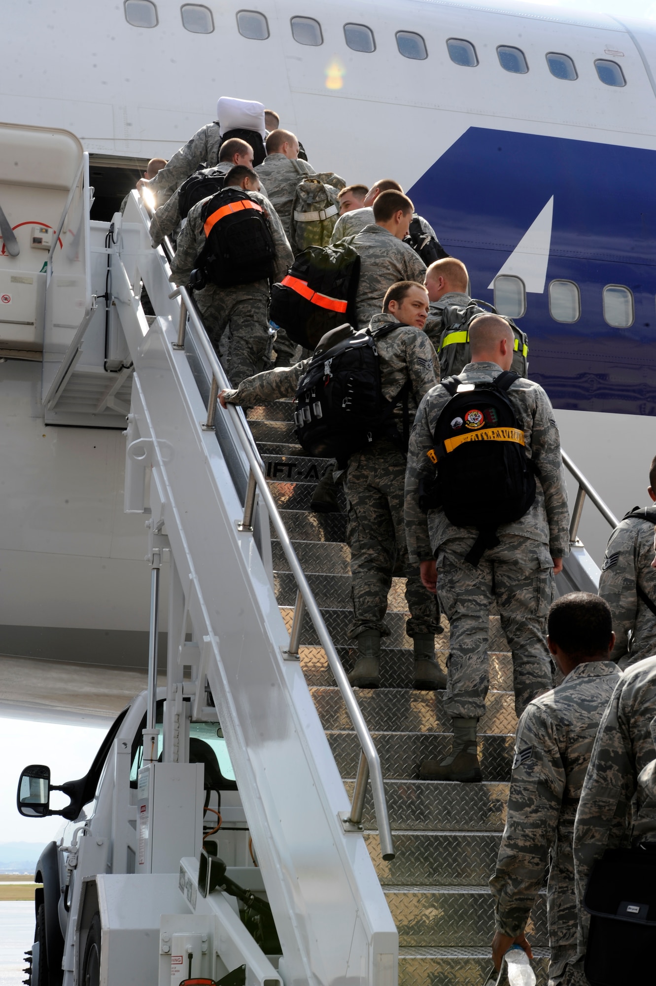 Approximately 350 Airmen from Ellsworth Air Force Base, S.D., file up the air stairs prior to departing on a six-month deployment to Southwest Asia, July 21, 2012. The Airmen will be supporting missions in the U.S. Central Command area of responsibility. (U.S. Air Force photo by Airman Ashley J. Cass/Released)