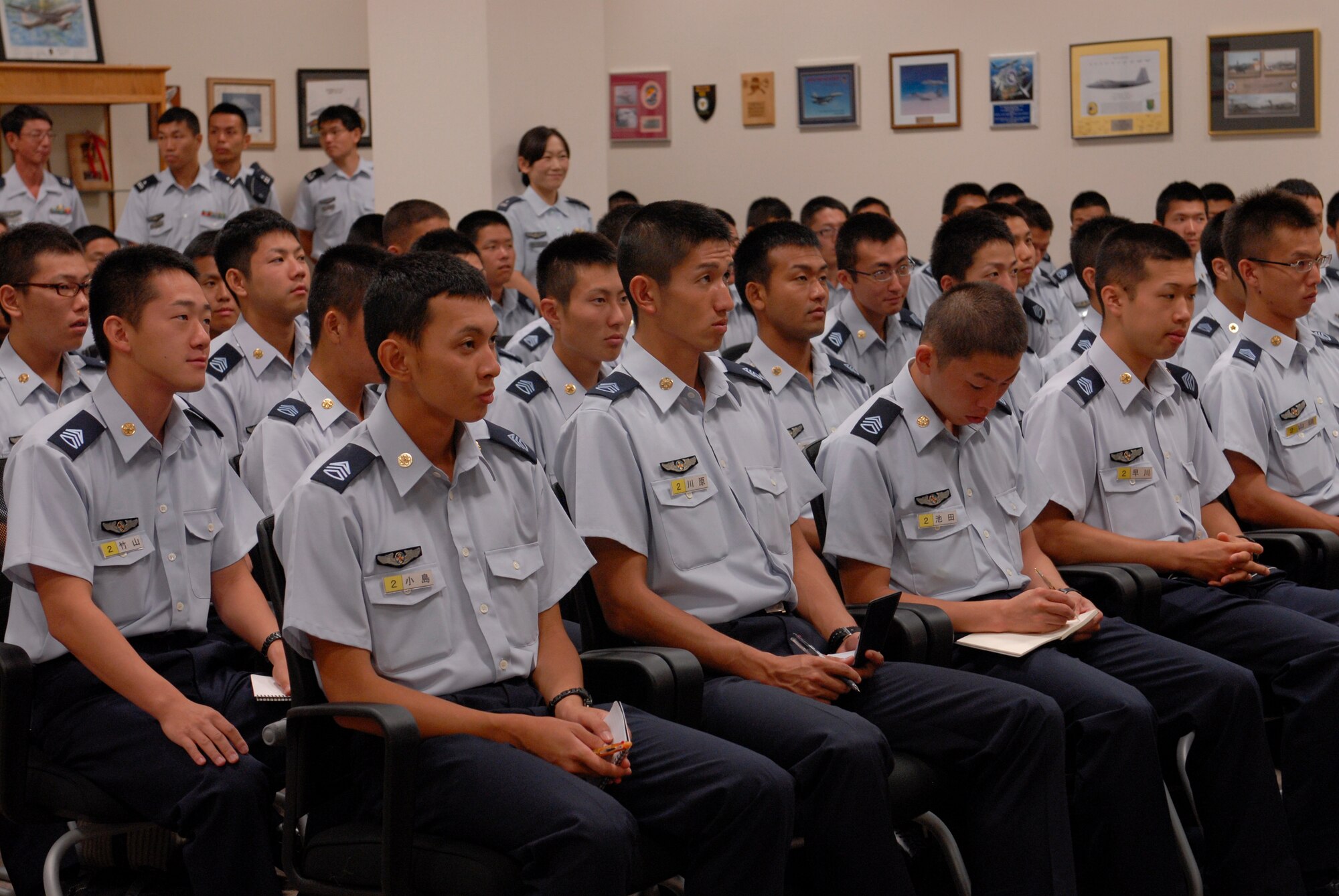 Japan Air Self Defense Force cadets from the Air Officer Candidate School in Nara Prefecture listen to an 18th Wing mission briefing and KC-135 Stratotanker and E-3 Sentry mission briefings on Kadena Air Base, Japan, July 19, 2012. "Opening doors to the Japanese is important for breaking down barriers. Approaching each other becomes easy once we are exposed to one another more often," said 1st Lt. David Smith, 909th Air Refueling Squadron flight scheduler. (U.S. Air Force photo/Airman 1st Class Malia Jenkins)   
