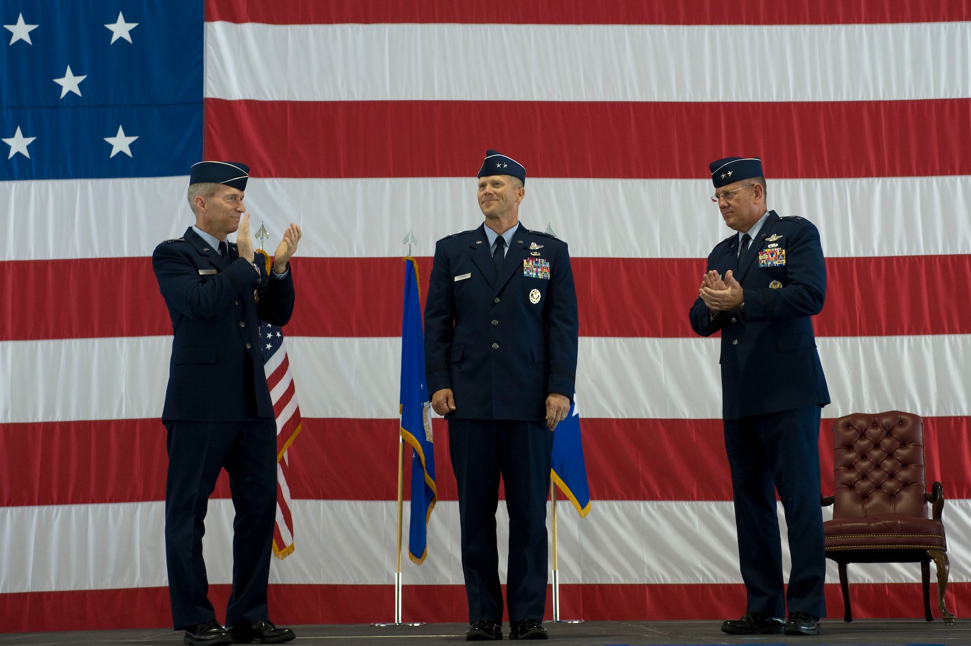U.S. Air Force Gen. Mike Hostage, commander of Air Combat Command, and Maj.
Gen. Bill Hyatt, previous U.S. Air Force Warfare Center commander, congratulate Maj. Gen. Jeffrey Lofgren upon his taking command during the USAFWC change of command ceremony July 20, 2012, at Nellis Air Force Base, Nev. Lofgren entered the Air Force in 1984 as a graduate of the U.S. Air Force Academy. Also a graduate of the U.S. Air Force Fighter Weapons School, he has served as an F-16 instructor pilot at Nellis and Luke AFB, Ariz. (U.S. Air Force photo by Airman 1st Class Christopher Tam/Released)
