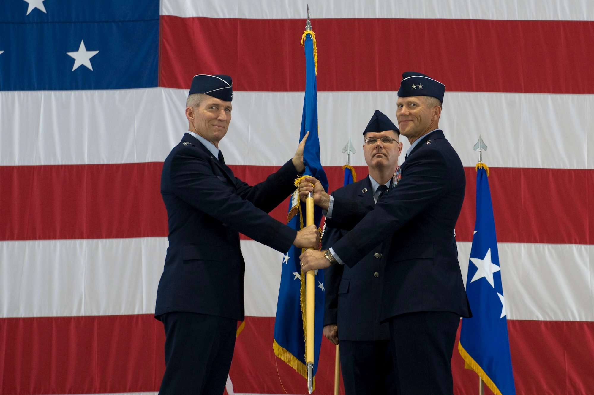 U.S. Air Force Gen. Mike Hostage, commander of Air Combat Command, passes
the guidon to Maj. Gen. Jeffrey Lofgren, U.S. Air Force Warfare Center
commander, during the USAFWC change of command ceremony July 20, 2012, at
Nellis Air Force Base, Nev. The USAFWC has six priorities: analyze adversaries, certify equipment, define tactics, train leaders, enhance performance, and integration of air, space and cyberspace domains. Overlooking the passing of the guidon is Chief Master Sgt. John Milam, 53rd Wing command chief. (U.S. Air Force photo by Airman 1st Class Christopher Tam/Released)
