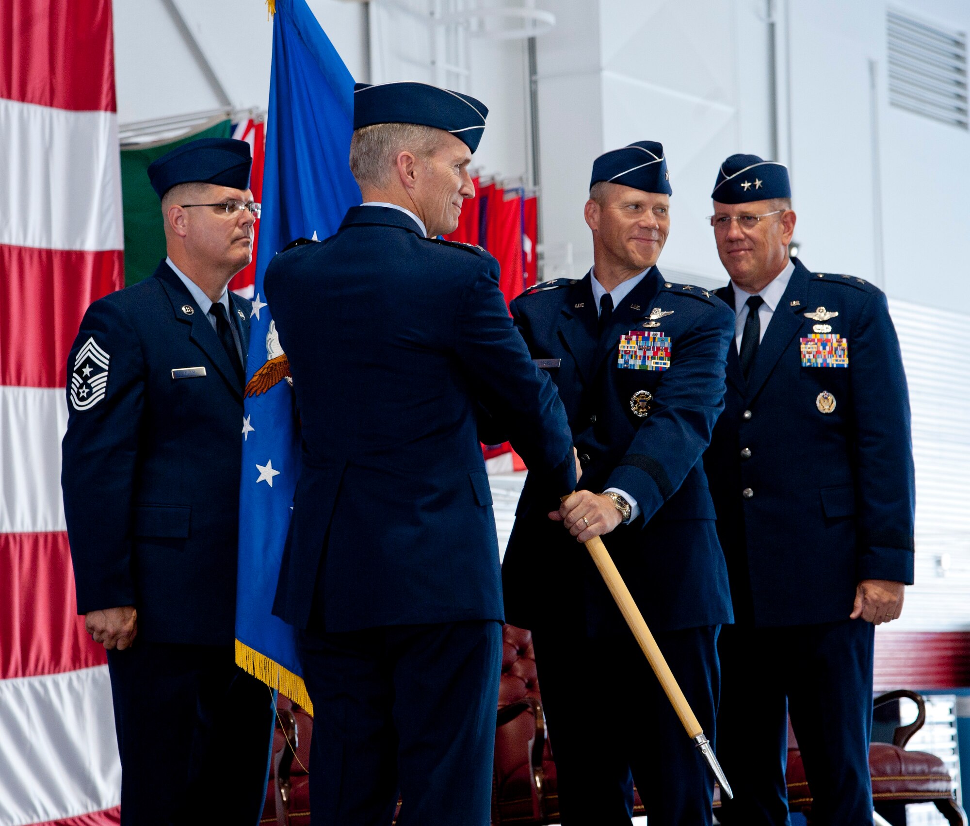U.S. Air Force Maj. Gen. Jeffrey Lofgren, U.S. Air Force Warfare Center
commander, receives the guidon from Gen. Mike Hostage, commander of Air Combat Command, symbolizing his assumption of command of the USAFWC during a
ceremony July 20, 2012, at Nellis Air Force Base, Nev. Lofgren succeeds Maj.
Gen. James Hyatt, who commanded the USAFWC since 2010. Also in the picture is Chief Master Sgt. John Milam, left, 53rd Wing command chief.(U.S. Air Force
photo by Master Sgt. Jason W. Edwards/Released)
