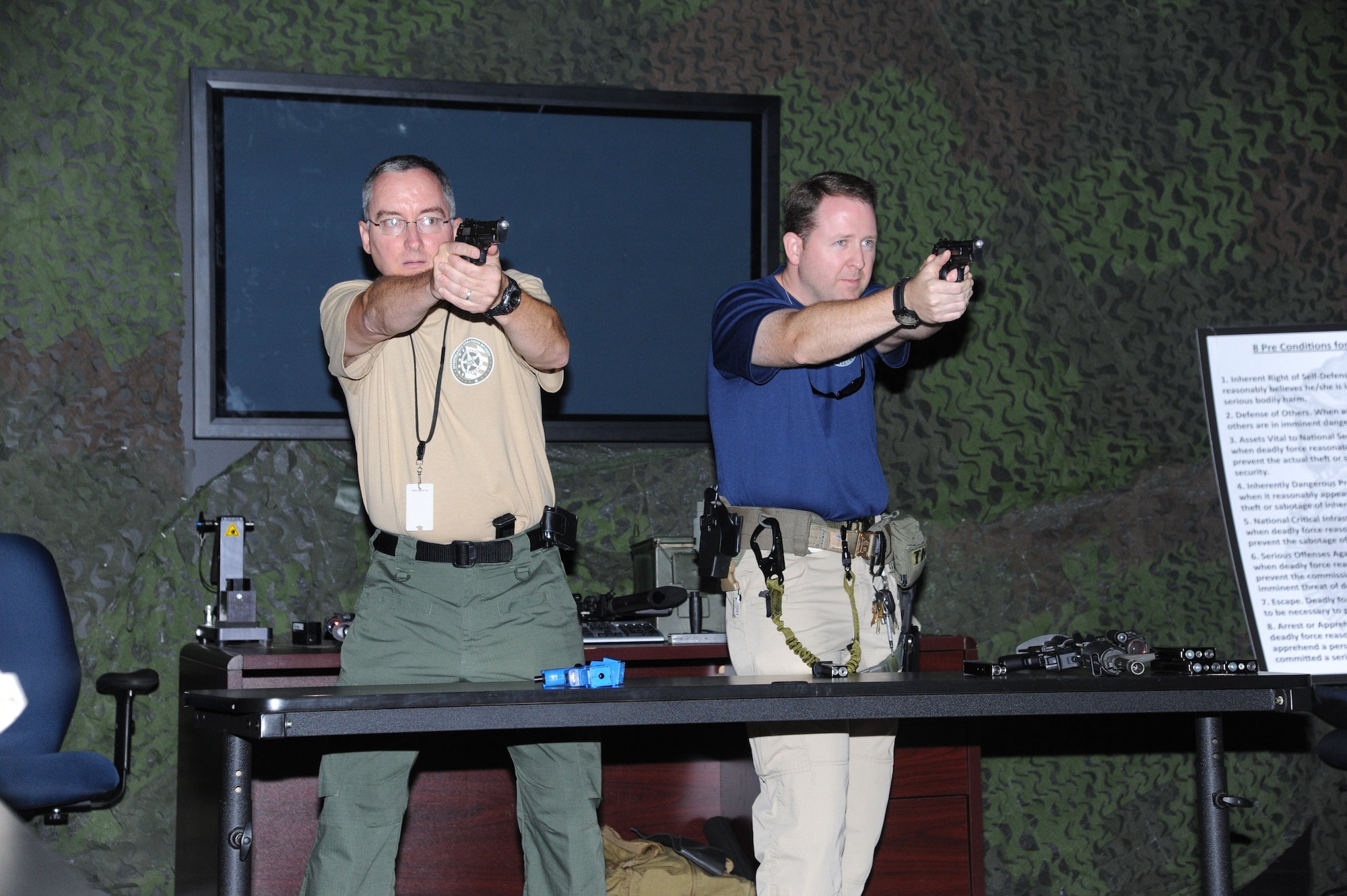 United States Deputy Marshals participate in an exercise using the 14th Security Forces Squadron’s Fire Arms Training Simulator July 19 at Columbus Air Force Base.  The FATS provides an on-screen simulated scenario of different plots than an officer could be called to and tests how well they react to each confrontation.  (U.S. Air Force Photo/Airman 1st Class Charles Dickens)