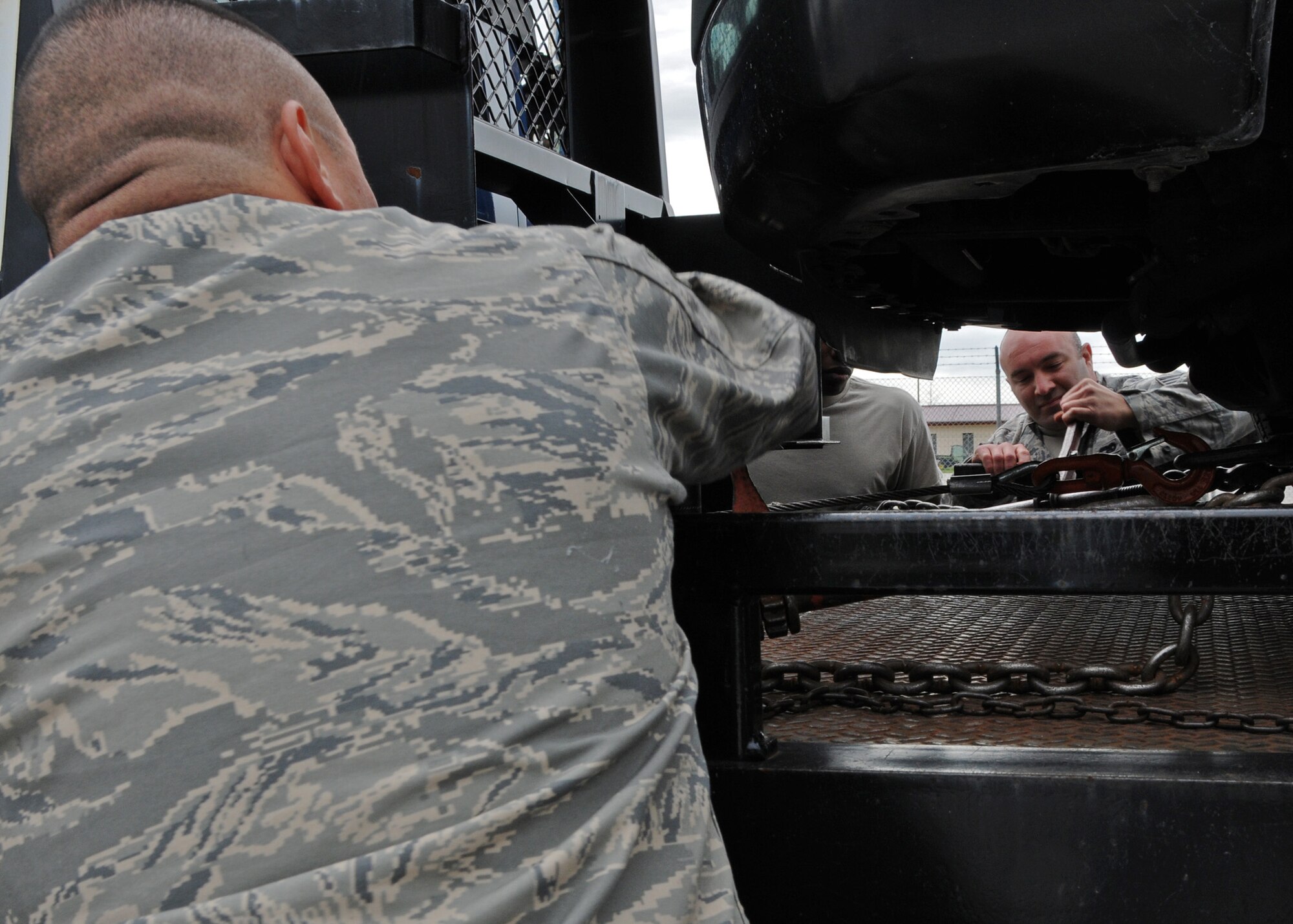 Technical Sgt. Oscar Martinez, left, and Staff Sgt. Joseph Sowden, 944th Logistics Readiness Squadron vehicle operators, secures a vehicle to a tow truck as part of their training during their Annual Tour to Aviano Air Force Base, Italy.  (U.S. Air Force photo by Staff Sgt. Louis Vega Jr.)