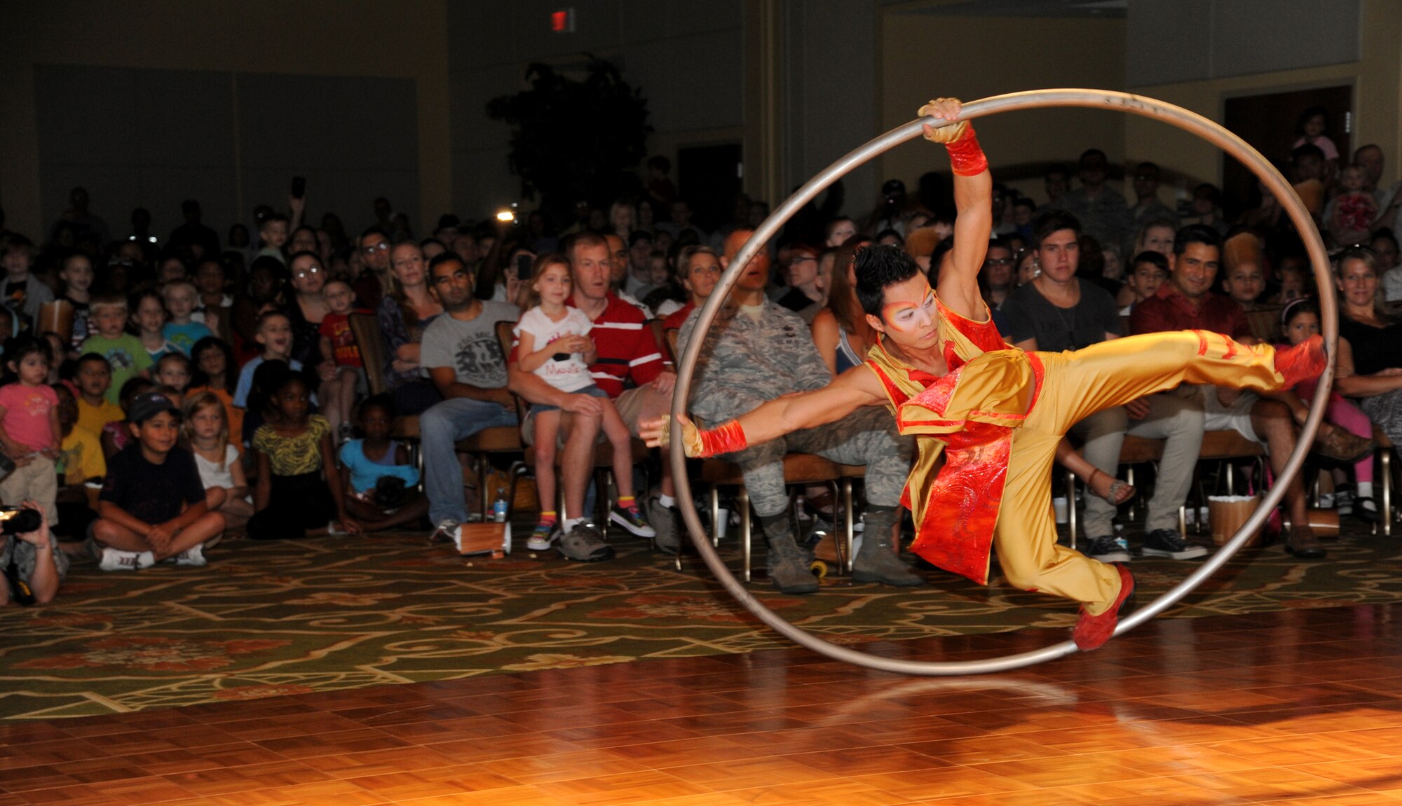 Raymond Silos, a member of Fata Morgana, performs on the Cyr Wheel during a military appreciation show for Keesler families July 21, 2012, at the Bay Breeze Event Center, Keesler Air Force Base, Miss.  Fata Morgana, an Italian phrase meaning optical illusion, featured a small number of various acts throughout the show.  (U.S. Air Force photo by Kemberly Groue)