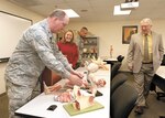 802nd Mission Support Group Commander Col. Richard Houghton and Chief Master James Glover, former 802nd MSG superintendent, visit a re-equipped base education center classroom as Russ Gregg, chief of education and training, 802nd Force Support Squadron, and Betsy Hamilton, off-site coordinator for St. Philip’s College at JBSA-Lackland, look on Jan. 13, 2011, during a tour of the facility. Upgrades to the base education center infrastructure took place during Houghton’s tenure as 802nd MSG commander. (U.S. Air Force photo/ Robin Cresswell)
